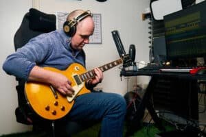 Rob Butler, Music Producer Recording Guitar Part at Studio Desk Yellow Guitar